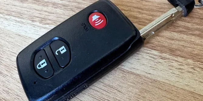 Car key fob with buttons for locking and unlocking.