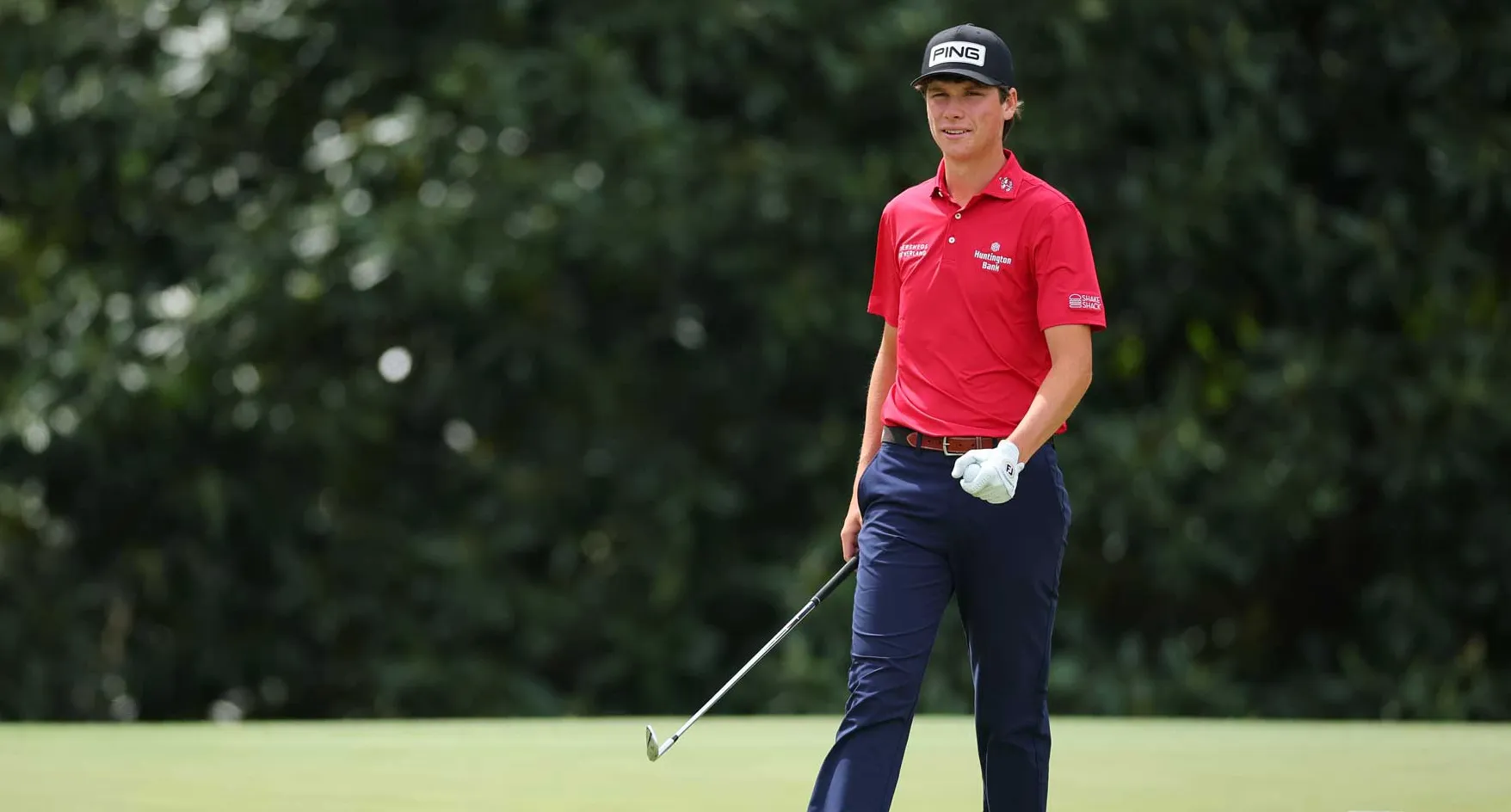 Mason Howell walks across green during a practice round at Augusta National